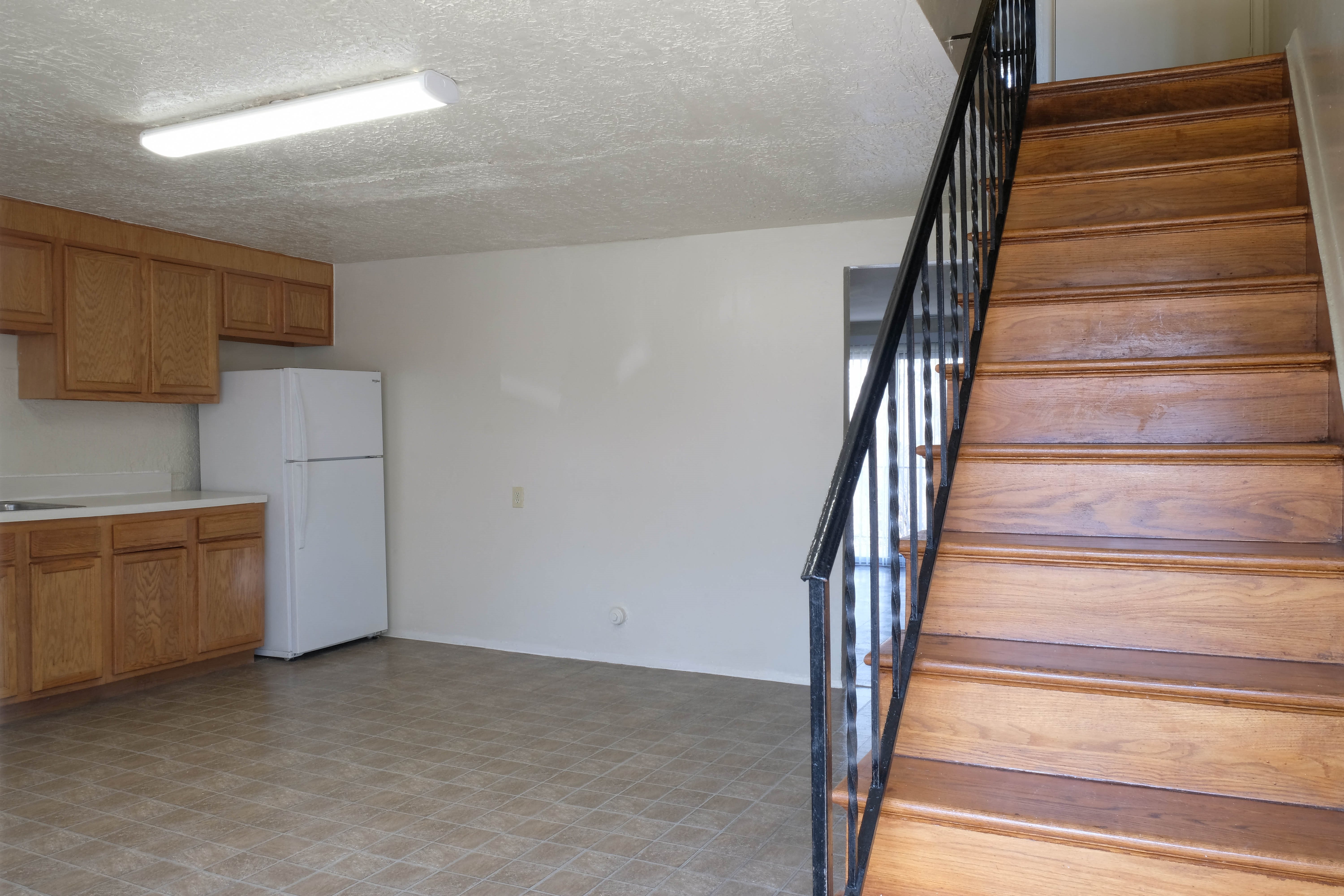 Living and dining room with view of stairs